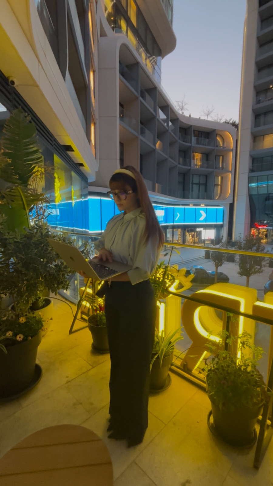 Asia Esposito working on a laptop outdoors at dusk